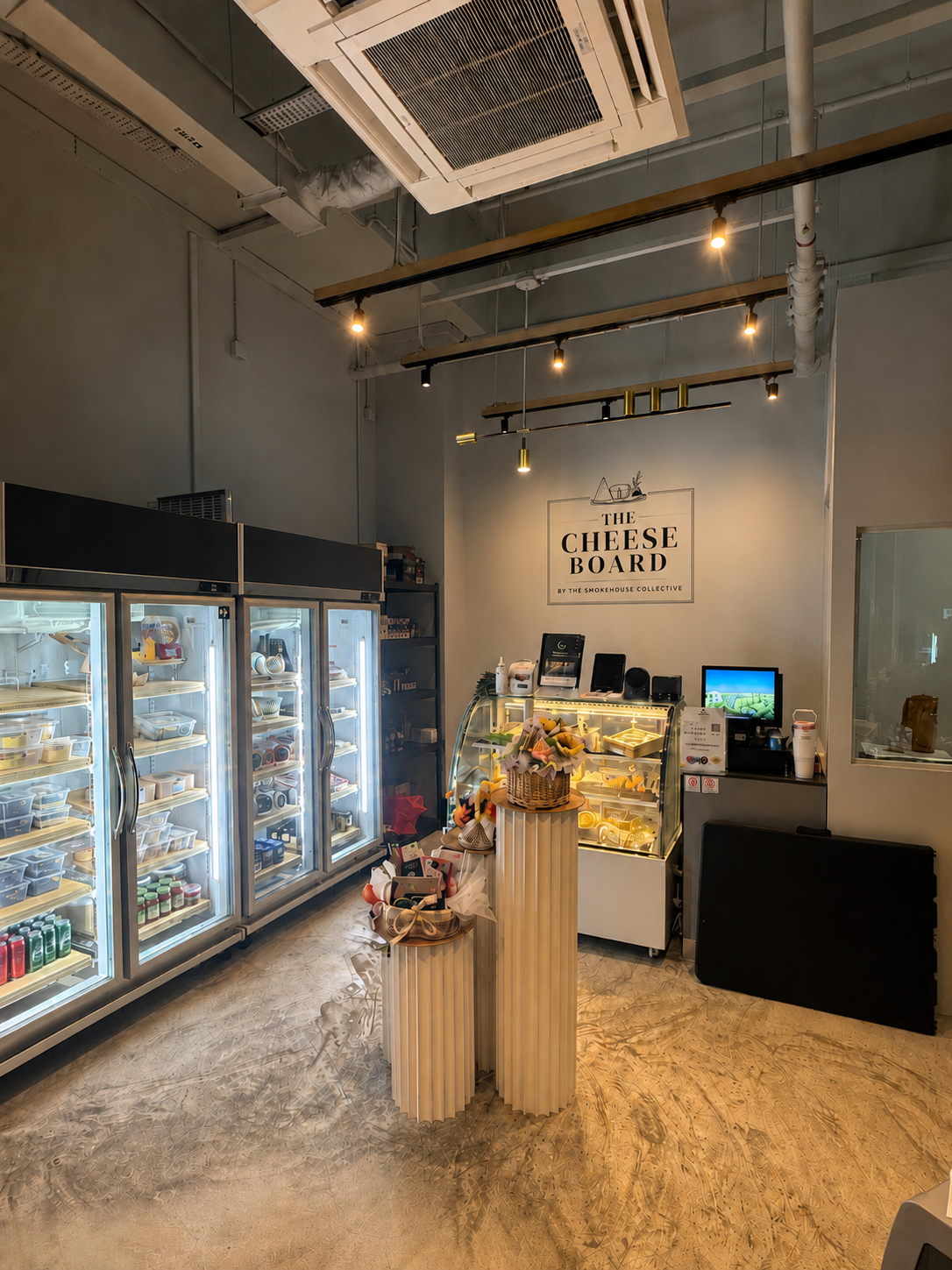 Inside The Cheese Board shop at NEWest Singapore — cheese counter and charcuterie